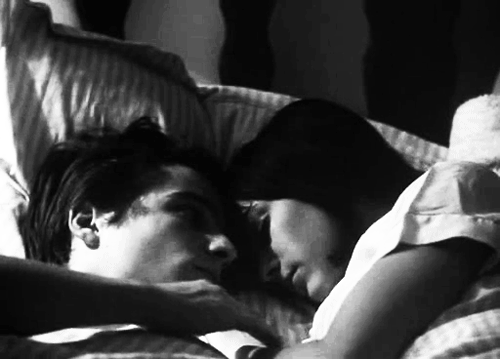 Мужчина целует женщину во сне. Нежный объятия в пастеле. Поцелуи в кровати. Объятия в постели. Утренний поцелуй.